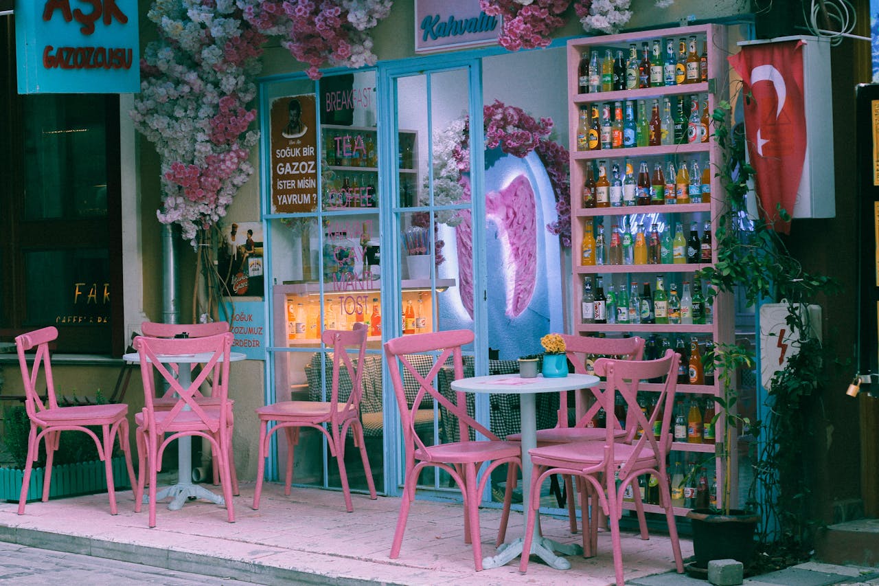 services-02 A delightful café with pink chairs and floral decor on a Turkish street at twilight.